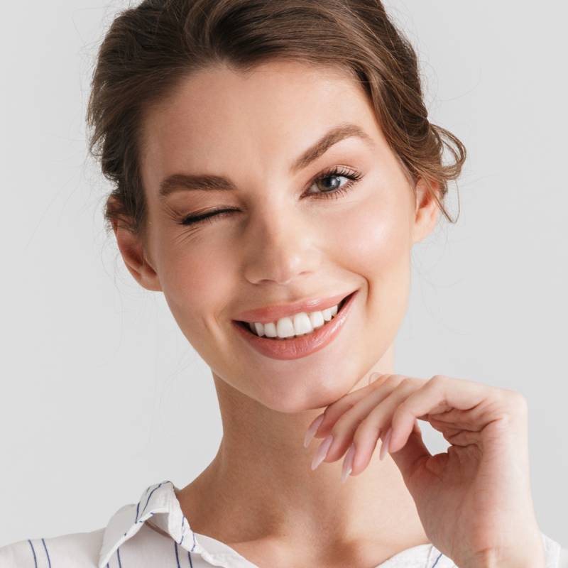 A smiling individual with beautiful, rejuvenated skin; text features a limited-time discount on a skin treatment at Springs Dermatology MD.